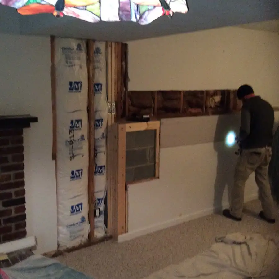 Restoration technician inspecting water damage in Nibley